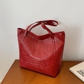 Large red crocodile pattern tote bag in premium faux leather on a wooden desk - Burgundy