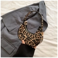 Detail of leopard print crescent bag showing texture, gold hardware, and zipper closure - Khaki
