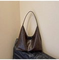 Detailansicht der dunkelbraunen Hobo-Tasche aus Kunstleder mit matter Vintage-Textur - Braun