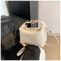 Close-up of cream white woven leather mini bag with gold buckle and adjustable strap - White