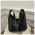 Detail of black pebbled leather hobo bag with wide shoulder strap and metal hardware - Black
