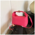 Bright pink woven crossbody bag with golden metal hardware for a trendy summer look - Pink