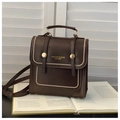 Vintage dark brown PU leather handbag with gold buckles and adjustable strap on books - Brown