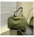 Detail of army green nylon travel tote bag showing front zip pocket and fabric texture - Army Green