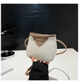 Detail of two-tone crossbody bag with lychee grain texture and metal hardware - White