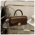Macro detail of dark brown vintage crossbody bag with gold round metal twist lock - Coffee Without Pendant