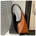 Close-up of black and brown panelled hobo bag with smooth PU leather texture and wide strap - Brown
