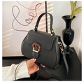 Elegant black lychee grain crossbody bag with stylish amber buckle and golden hardware - Black