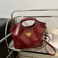Polished burgundy faux leather tote bag with gold metal logo and braided charm - With Pendant / Red