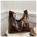 Detail of dark brown faux leather tote bag with plush bear charm and knotted shoulder strap - Coffee with Pendant