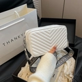 White quilted crossbody bag with chevron stitching and patterned wide woven strap - White