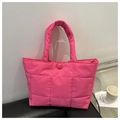 Detail of fuchsia quilted nylon tote bag featuring a round buckle and padded texture - Rose Pink