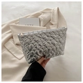 Close-up of metallic silver quilted heart makeup bag with golden zipper and waterproof fabric - Silver