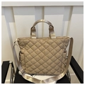 Detailed view of quilted tote bag with side pocket and adjustable nylon strap - Khaki
