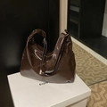 Minimalist large dark brown tote bag in glossy leather finish on a white display pedestal - Coffee Without Pendant