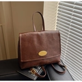 Deep brown vintage oil wax leather backpack with gold metal emblem and adjustable straps - Coffee