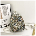 Detail of floral jacquard mini backpack showing woven fabric and white zipper strap - White Type 1