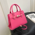 Elegant rose red faux leather handbag with gold twist lock and a sleek belt design - Rose Red