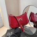 Chic red underarm bag featuring faux crocodile texture and a golden metal bow accent - Crocodile Pattern Red