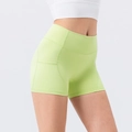 High-waisted yoga shorts in vibrant lime green with side pockets and elastic fabric - S / Bottoms / Fruit Green