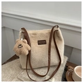 Close-up of beige faux fur tote bag with brown leather strap and cute teddy bear charm - Khaki With Pendant
