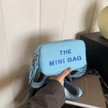 Light blue pebbled leather mini crossbody bag with a patterned wide shoulder strap - Blue