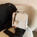 Minimalist white square handbag with leather handle and decorative brown tassel charm - White With Pendant