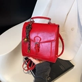 Vintage red glossy leather square backpack with decorative pendant and metallic hardware - Burgundy Red With Charm