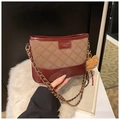 Detail of quilted stitching and leather logo label on brown chain hobo shoulder bag - With Pendant / Brown