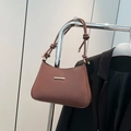Elegant brown underarm bag with knotted shoulder strap and gold hardware accents - Brown