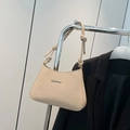 Elegant beige underarm bag with gold metal trim and decorative knot strap detail - Khaki