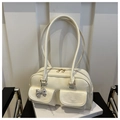 Chic cream white shoulder bag with double front pockets and metallic bow charm detail - White