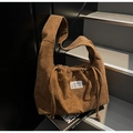 Macro detail of brown corduroy tote bag showing textured fabric and drawstring closure - Khaki