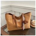 Dettaglio della borsa tote in pelle scamosciata marrone con scritta bianca e ciondolo cane - Con Ciondolo / Marrone Scuro