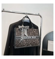 Detail view of large leopard print tote bag with stylish scarf and fashion text on hanger - Gray