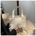 Detail view of cream lychee texture leather bucket bag with Cameron & Bags logo and zipper - White Without Pendant
