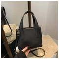 Detail of black lychee grain leather tote bag with gold hardware and logo embossing - Black Without Pendant