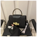 Elegant black crocodile pattern handbag with gold circular handle and wave metal clasp - Black
