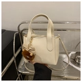 Cream lychee leather bucket bag with fur charm and adjustable long strap - White With Pendant