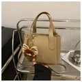 Minimalist khaki lychee grain leather bucket bag with a cute plush bow pendant - Khaki With Pendant
