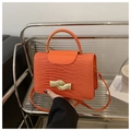 Orange faux crocodile leather crossbody bag with curved metal handle and gold clasp - Orange