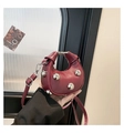 Burgundy half-moon crossbody bag with silver rivet accents and top handle design - Red