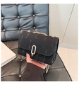 Detail of black denim shoulder bag with vintage frayed edges and gold U-shaped metal buckle - Black