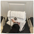 Detail view of white quilted faux leather bag with silver twist lock and chain strap - White