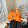 Bright orange small square bag with silver star hardware and top handle for women - Orange