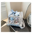 Detail of grey ita bag featuring transparent PVC pocket with blue lace bows and plush charms - Silver with Charm