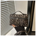 Close-up of leopard print handbag showing detailed stitching and textured synthetic leather - Black