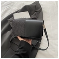 Detail of minimalist black crossbody bag with silver glitter and faux leather stitching - Black