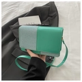 Detail of green textured patchwork crossbody bag with elegant gold-tone hardware accents - Green