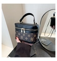 Detail of vintage box bag with leather stitching and gold chain in a mirror reflection - Coffee